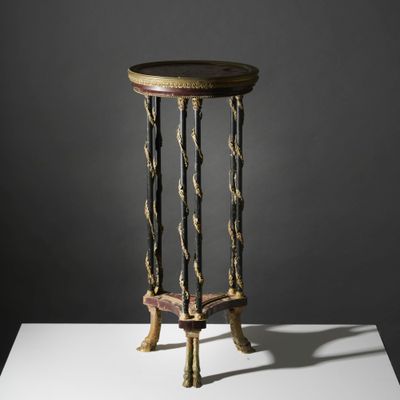a small table with a wooden top on a white surface
