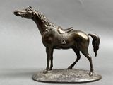bronze statue of a horse with a saddle on it ' s back