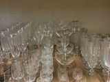 many wine glasses on the shelf in the kitchen
