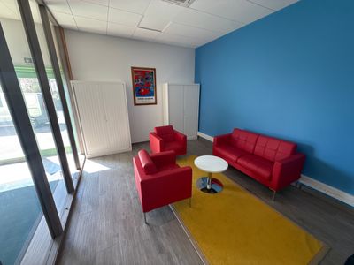 two red couches and a yellow rug in a room