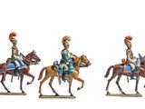 three figurines of men riding on horses on a white surface