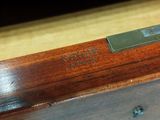 a close up of a piece of wood with a metal plate on top of it