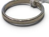 a silver ring with a knot on it on a white surface