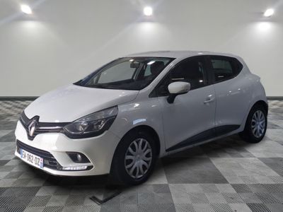 la voiture blanche est garée sur un sol en damier dans le garage