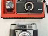 two cameras sitting next to each other on a table