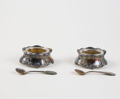 pair of silverplated candlesticks with spoons and spoon rest