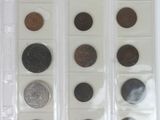 a lot of coins in a plastic case on a table