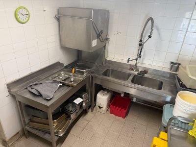 a kitchen with a sink, stove, and other items in it