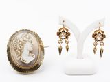 a close up of a pair of earrings on a stand