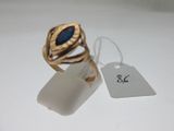 an image of a gold ring with a blue stone on it