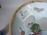 a bird that is sitting on a plate that has a tag on it