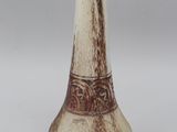 an image of a vase with a brown and white decoration