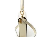 beige and black handbag with strap on white background on a white surface