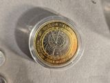 a coin sitting on top of a table next to other coins
