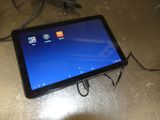 a tablet that is connected to a charger on the table