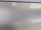 a close up of a car ' s front bumper with a small dent
