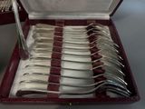 silverware in a red case on a table with silverware in it