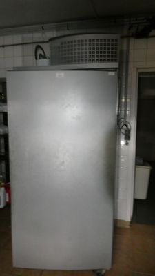 an image of a refrigerator in a kitchen with tile flooring