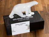 a white bear figurine sitting on top of a black box