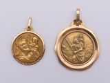two gold pendants depicting the virgin and child jesus
