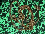 green and black leopard print fabric with a gold chain on it