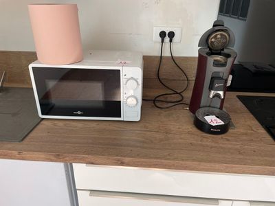 a microwave and a coffee maker on a kitchen counter