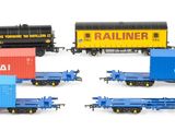 several toy trains are lined up in a row on a white surface