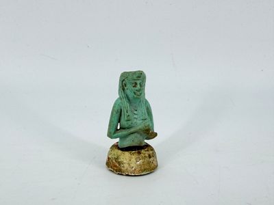 an image of a statue of a person sitting on top of a rock