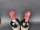 two bottles of wine sitting next to each other on a table