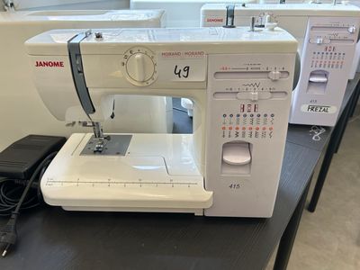 a white sewing machine sitting on a table in a room