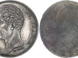 a close up of a coin with a man ' s face on it