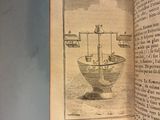 an open book with a drawing of a boat in a bowl on it