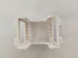 a close up of a white plastic object on a white surface