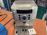 a coffee machine sitting on a table with a price tag on it