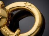 an image of a close up of a gold plated keychain