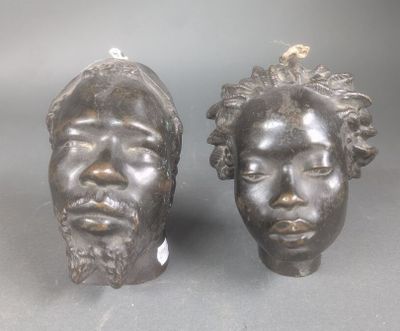 une paire de sculptures en bronze représentant un homme et une femme aux cheveux bouclés