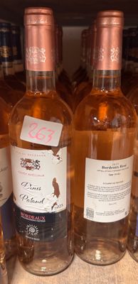 several bottles of wine are lined up on a shelf in a store