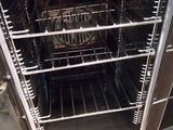 an open oven with the door open and a sign on it