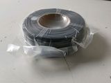 a close up of a roll of black electrical tape on a table