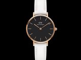 a black and rose gold watch with a white strap