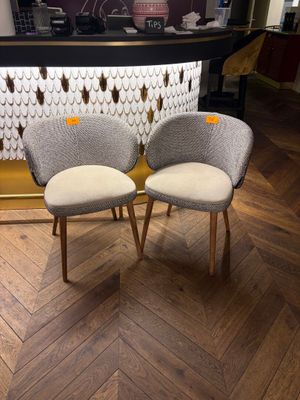 pair of mid - century style chairs in the lobby of a hotel