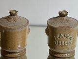 two brown vases sitting on a glass table