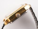 a close up of a watch on a white surface