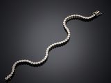 a diamond and white gold bracelet, by cartier