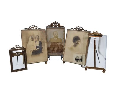 three framed photographs of a man and a woman on a tripod stand