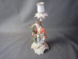 a figurine of a man with a lamp on a table