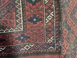 a close up of a rug with a red and blue design on it