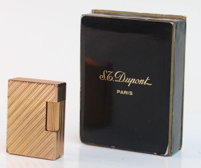 a close up of a box of perfume next to a lighter
