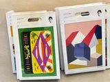 three boxes with different designs on them sitting on a table