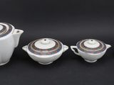 four pieces of porcelain tea and coffee set on a black background